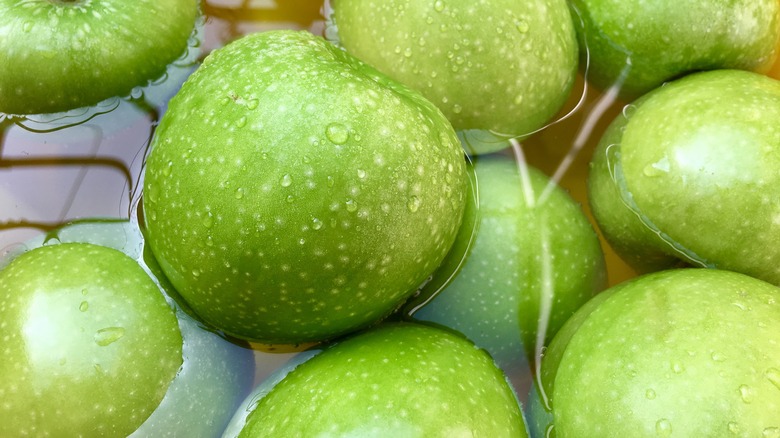 Green apples soaking in water
